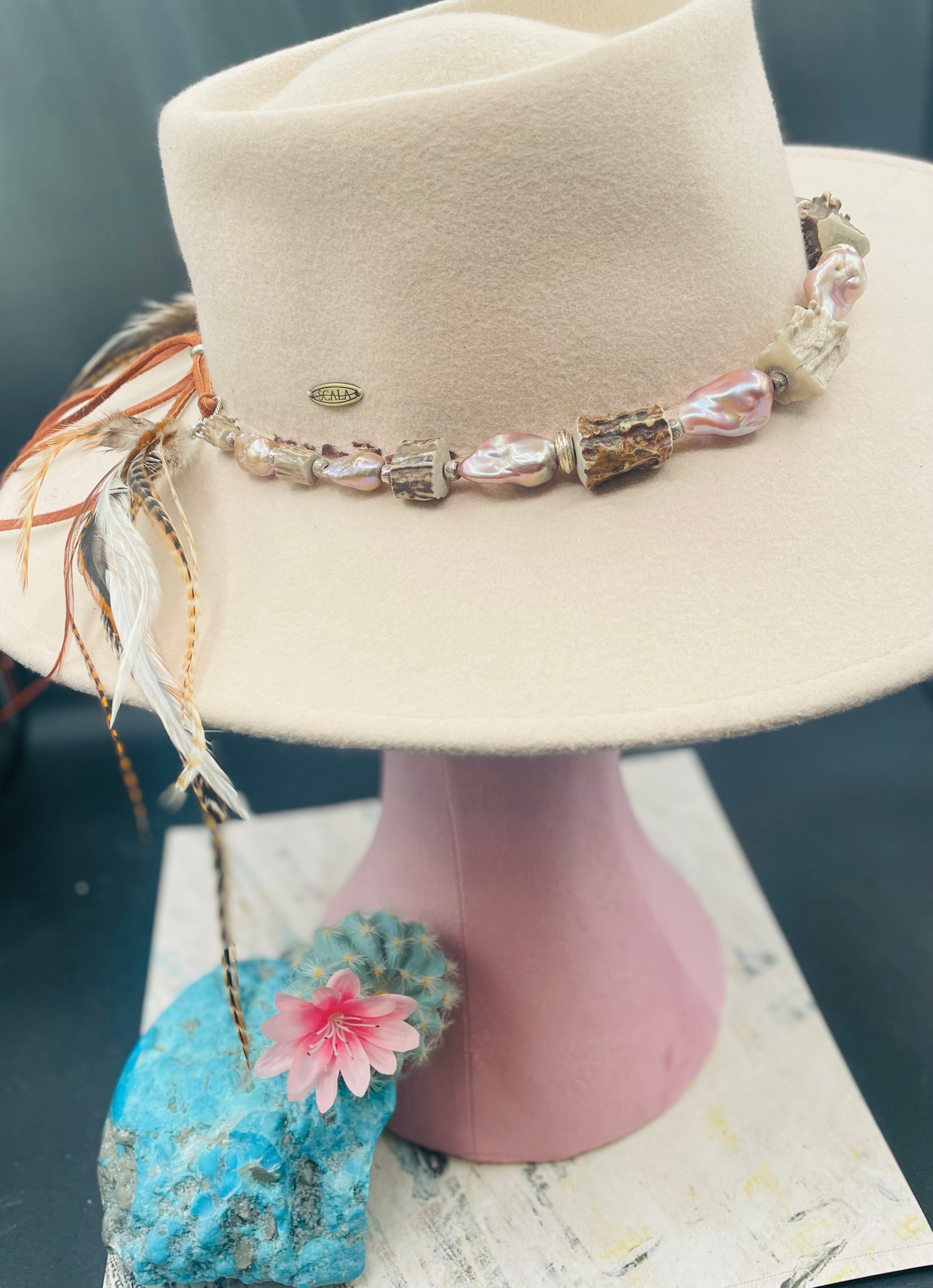 Hatband or necklace with giant baroque natural luster pearls, knobby deer antler beads, and  sterling silver beads and finished with feathers, deer lace, and a slide bead. Available only from Rockstar Cowgirl online or in store in Cody, Wyoming.