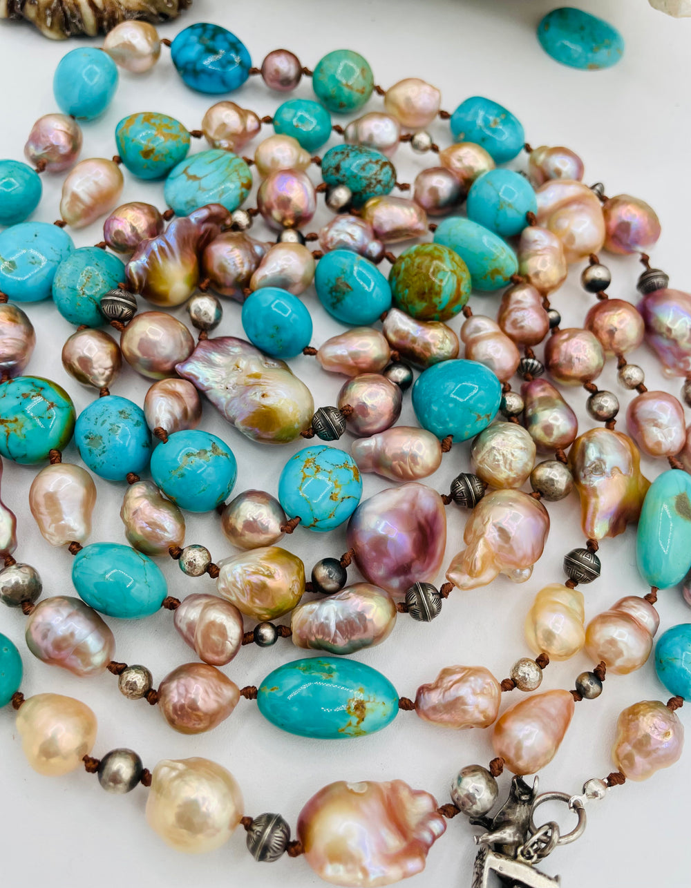 Silk knotted lariat necklace featuring baroque natural luster pearls, Kingman turquoise nuggets, and sterling silver beads. Available only from Rockstar Cowgirl online or in store in Cody, Wyoming.