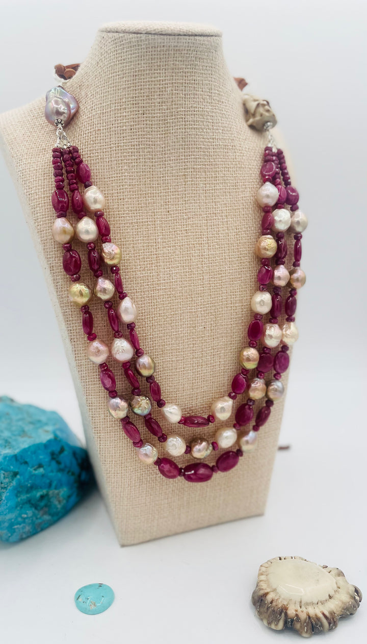 Adjustable 3 strand necklace featuring ruby, Edison pearls, flameball baroque pearl, textured deer antler bead, and finished with deer lace. Available only from Rockstar Cowgirl online or in store in Cody, Wyoming.