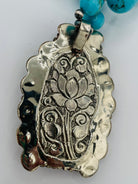 Necklace featuring Kingman turquoise nuggets, sterling silver beads, and carved bone pendent. Available only from Rockstar Cowgirl online or in store in Cody, Wyoming.