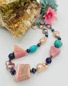 Chunky necklace featuring giant pink Peruvian opal nuggets, AAA grade natural luster baroque pearls, purple Mojave turquoise, and sterling silver Navajo pearl beads. Available only from Rockstar Cowgirl online or in store in Cody, Wyoming.