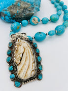 Necklace featuring Kingman turquoise nuggets, sterling silver beads, and carved bone pendent. Available only from Rockstar Cowgirl online or in store in Cody, Wyoming.