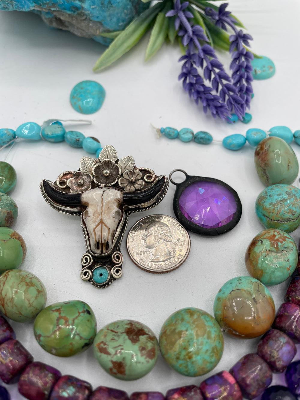 Bead box featuring Sonoran turquoise, sodalite, fruity purple turquoise, green Kingman turquoise nuggets, amethyst, steer pendent and crystal charm. U.S. Quarter for size reference. Available only from Rockstar Cowgirl online or in store in Cody, Wyoming. 