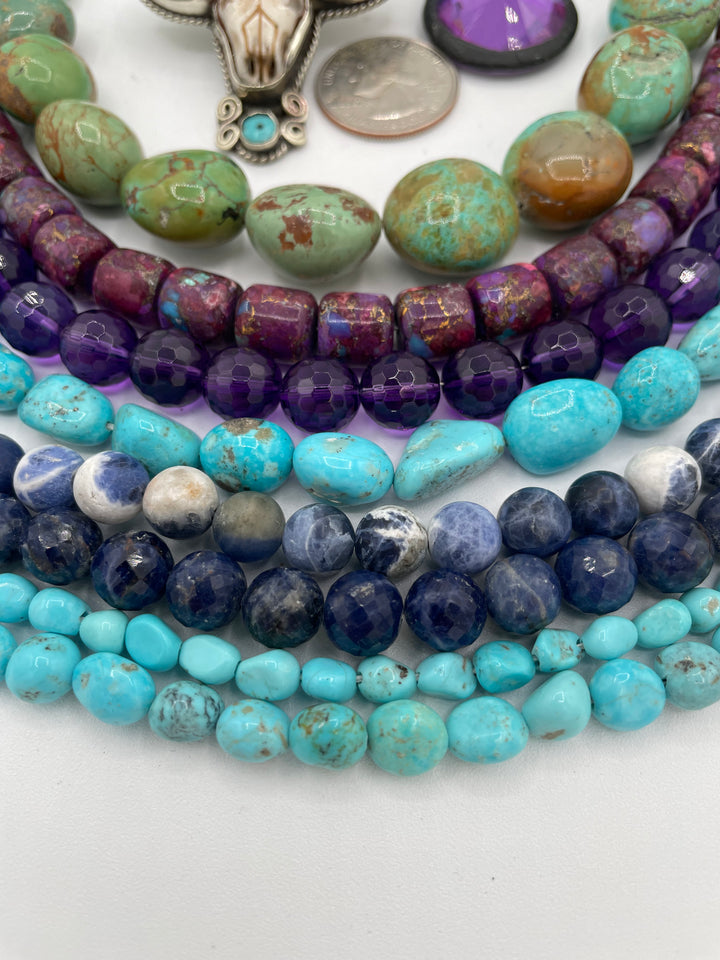 Bead box featuring Sonoran turquoise, sodalite, fruity purple turquoise, green Kingman turquoise nuggets, amethyst, steer pendent and crystal charm. U.S. Quarter for size reference. Available only from Rockstar Cowgirl online or in store in Cody, Wyoming. 