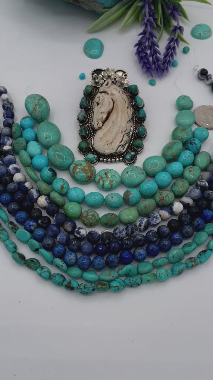 Bead box featuring Kingman turquoise nuggets in 3 colors, sodalite calcite, sodalite, denim lapis, Hubei turquoise, and carved bone horse and turquoise pendent. U.S. quarter for size reference. Available only from Rockstar Cowgirl online or in store in Cody, Wyoming.
